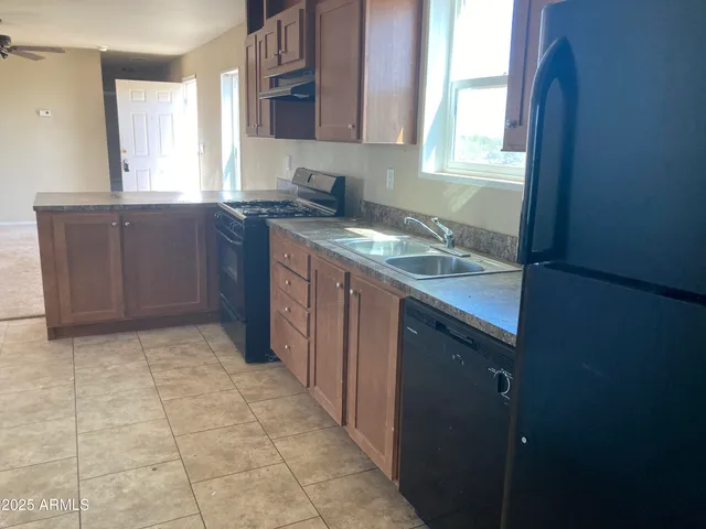 a kitchen with a sink window and cabinets