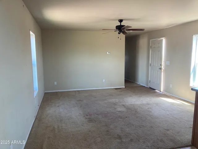 a view of a big room with a chandelier fan