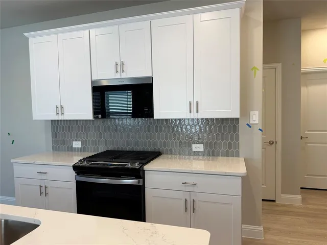a kitchen with a sink and cabinets
