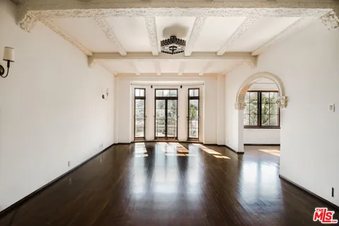 a view of an entryway with a floor to ceiling window and wooden floor