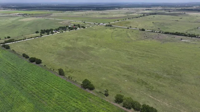 a view of a field with an ocean view