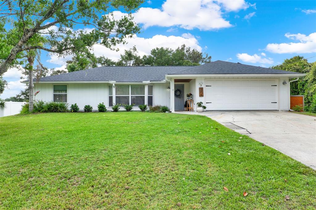 2674 Flowing Well Road DeLand, FL 32720 - Photo 1 of 1 a front view of house with yard and green space