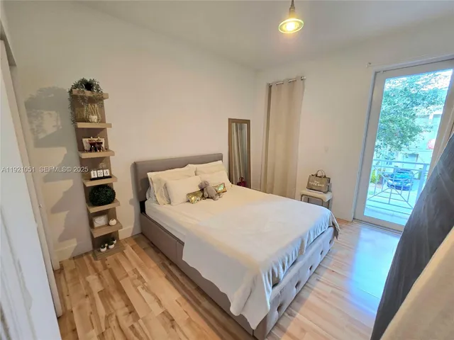 a view of a chair and table in backyard of the house