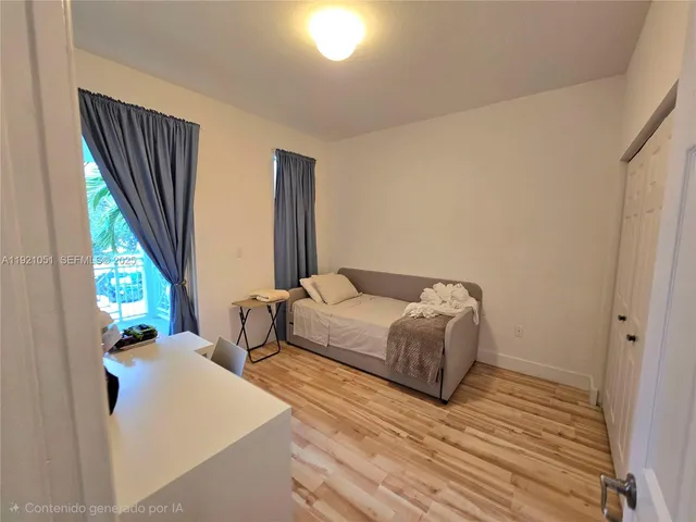 a view of a backyard with large trees and wooden fence