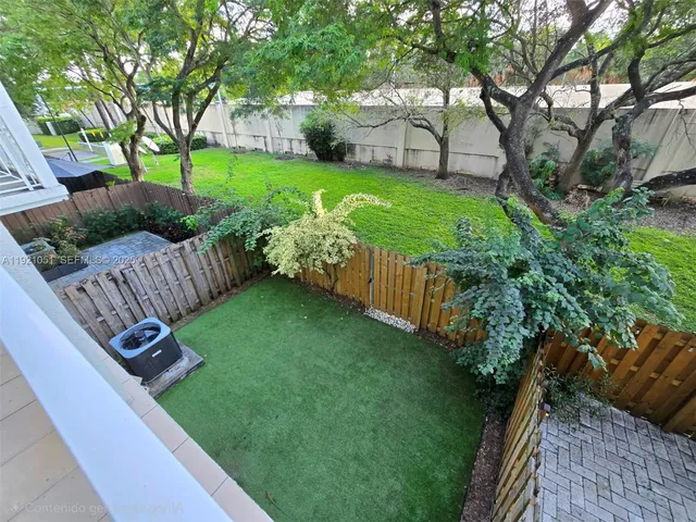 a play ground with potted plants and palm trees