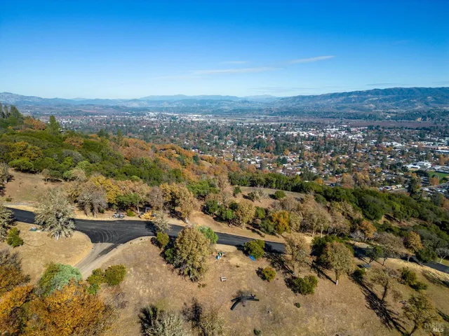 an aerial view of residential building and trees around
