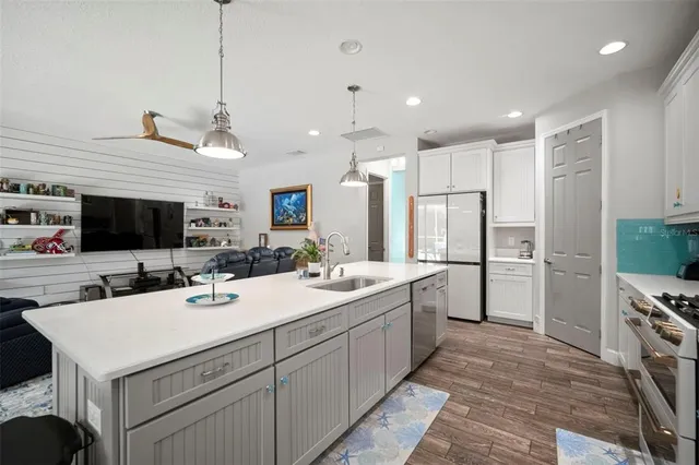 a bedroom with a large bed and wooden floor