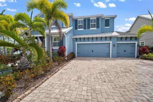 a view of a house with a yard and potted plants