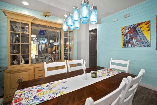 a kitchen with kitchen island granite countertop a sink a center island a stove cabinets and living room view