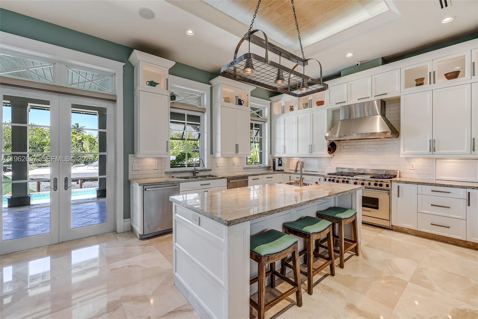 9320 Balada Street Coral Gables, FL 33156 - Photo 19 of 75 a kitchen with stainless steel appliances granite countertop a stove top oven a sink and a refrigerator