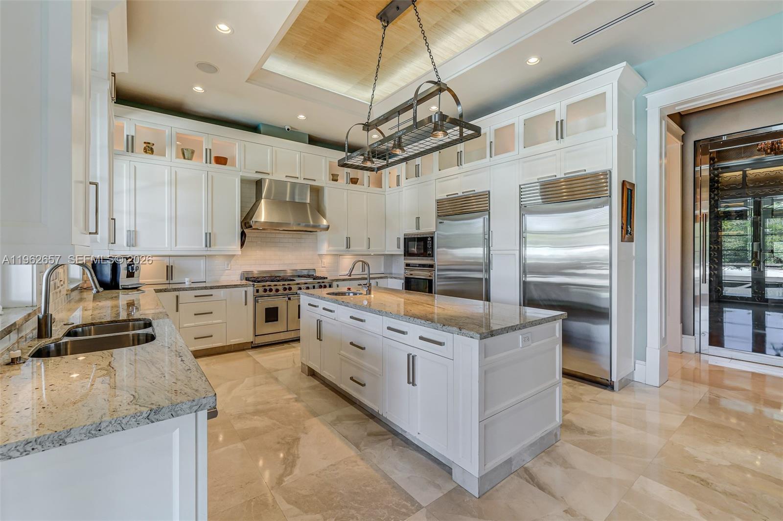 9320 Balada Street Coral Gables, FL 33156 - Photo 21 of 75 a kitchen with stainless steel appliances granite countertop a sink counter space cabinets and stainless steel appliances