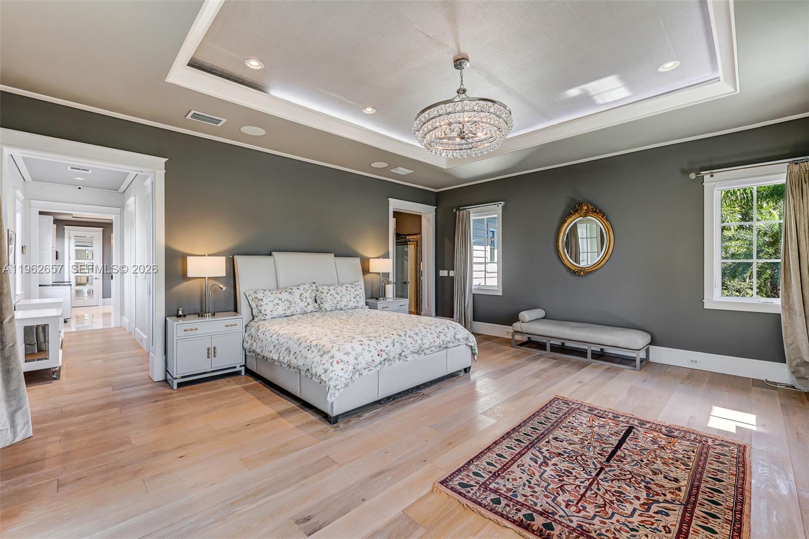 9320 Balada Street Coral Gables, FL 33156 - Photo 35 of 75 a bedroom with a bed and a chandelier