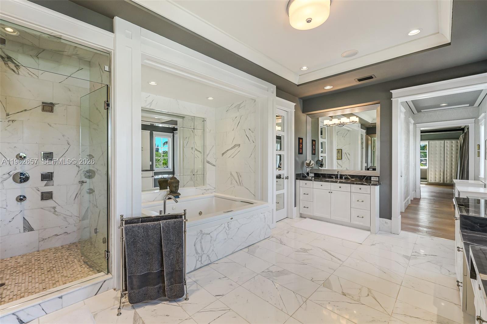 9320 Balada Street Coral Gables, FL 33156 - Photo 39 of 75 a large en suite bathroom with a granite countertop tub shower and mirror