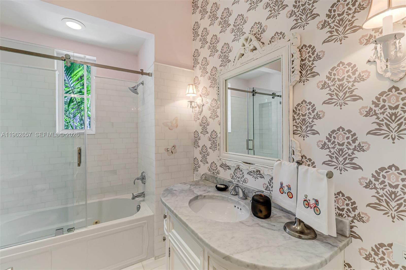 9320 Balada Street Coral Gables, FL 33156 - Photo 49 of 75 a bathroom with a tub sink and mirror