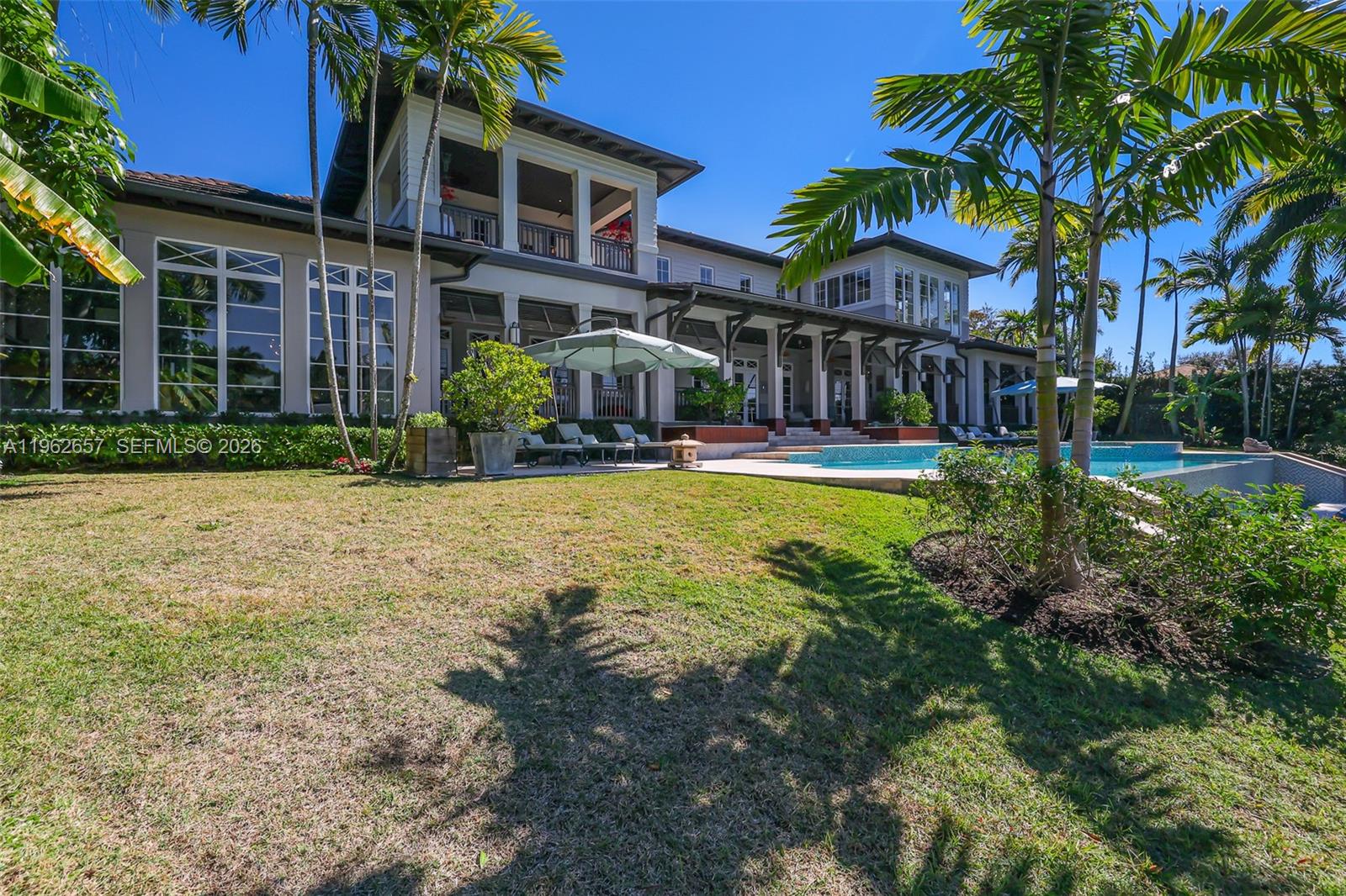 9320 Balada Street Coral Gables, FL 33156 - Photo 64 of 75 a view of a house with swimming pool and a yard