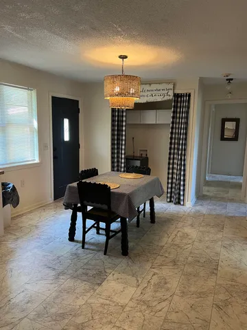 a bedroom with furniture and a chandelier