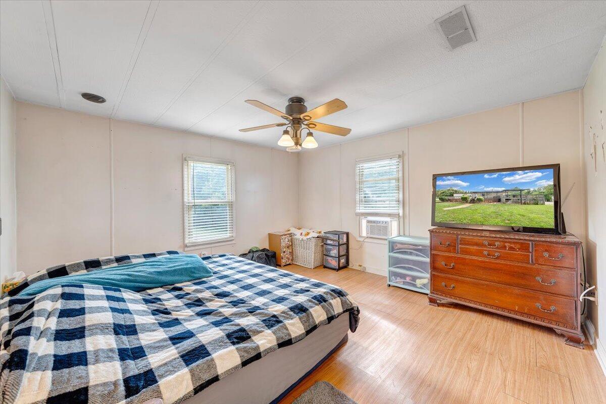 164 Tabernacle Road Penhook, VA 24137 - Photo 16 of 58 a bedroom with a bed and a chandelier