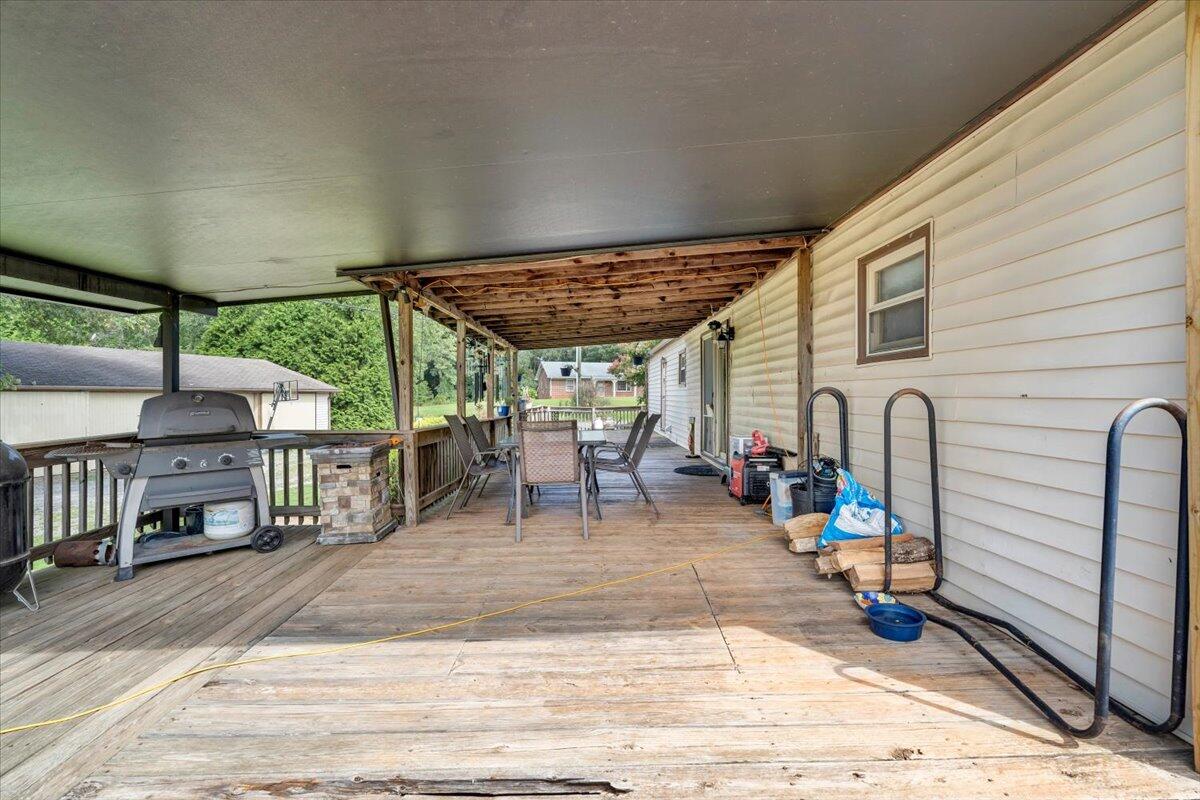 164 Tabernacle Road Penhook, VA 24137 - Photo 28 of 58 a view of a patio with a table and chairs under an umbrella