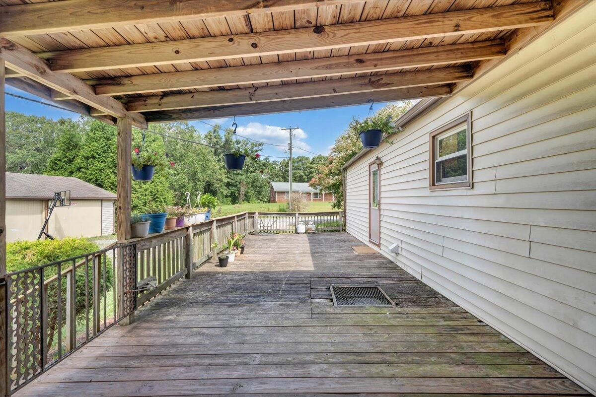 164 Tabernacle Road Penhook, VA 24137 - Photo 31 of 58 a view of a deck with wooden floor and roof with a potted plant
