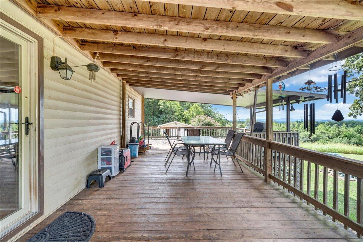 164 Tabernacle Road Penhook, VA 24137 - Photo 34 of 58 a patio with table and chairs and wooden floor
