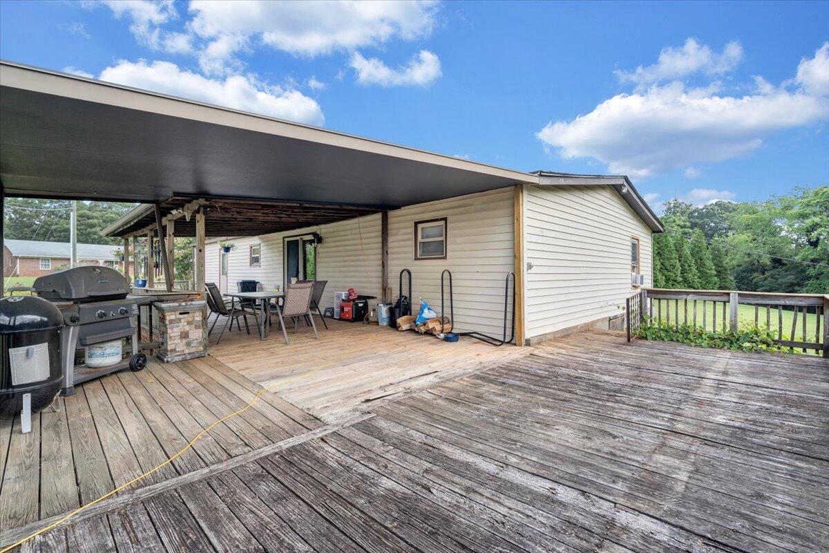 164 Tabernacle Road Penhook, VA 24137 - Photo 36 of 58 a view of a patio with table and chairs with wooden floor and fence