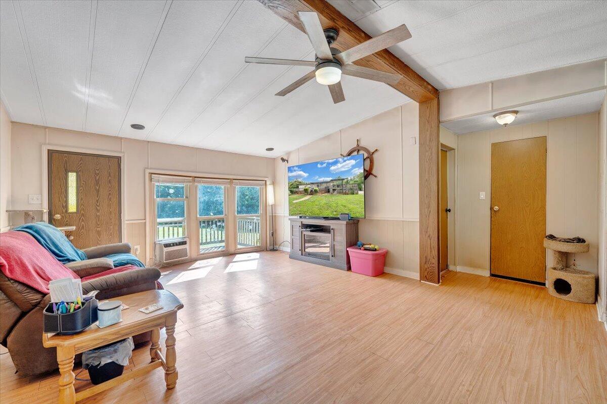 164 Tabernacle Road Penhook, VA 24137 - Photo 4 of 58 a living room with furniture a window and a flat screen tv