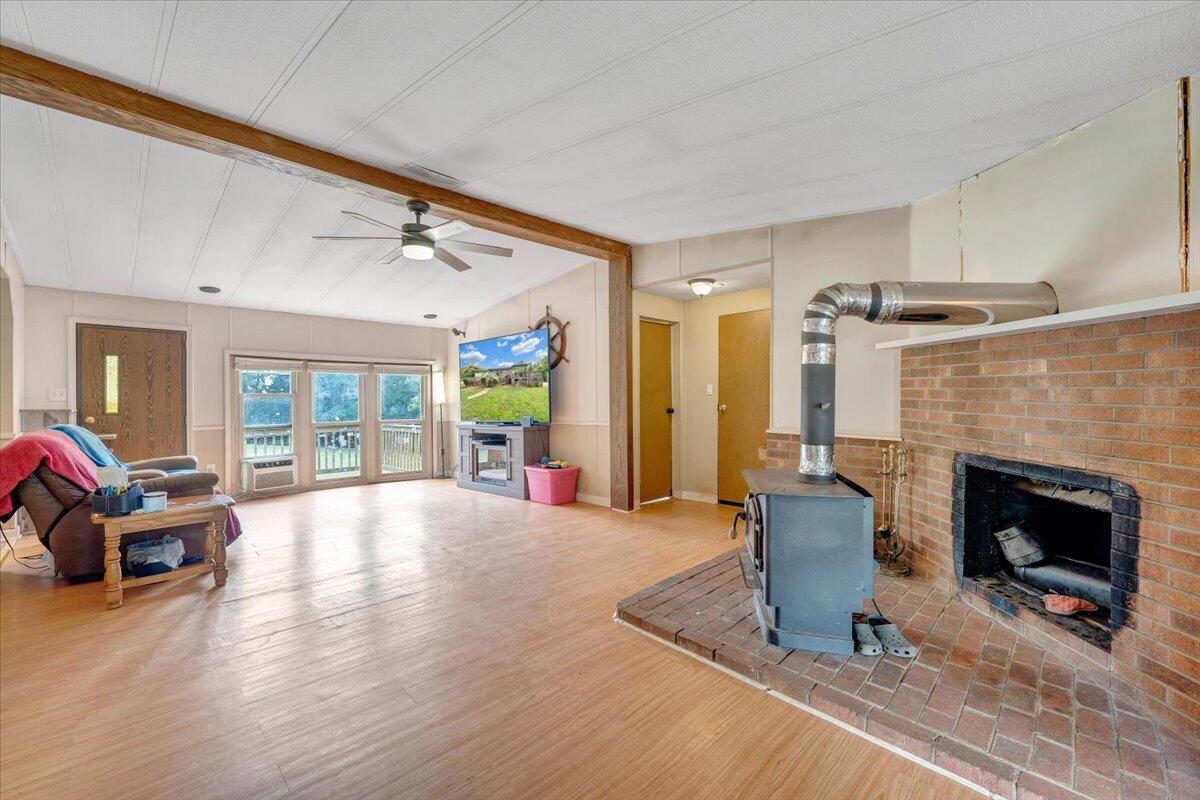 164 Tabernacle Road Penhook, VA 24137 - Photo 9 of 58 a living room with furniture a fireplace and a table