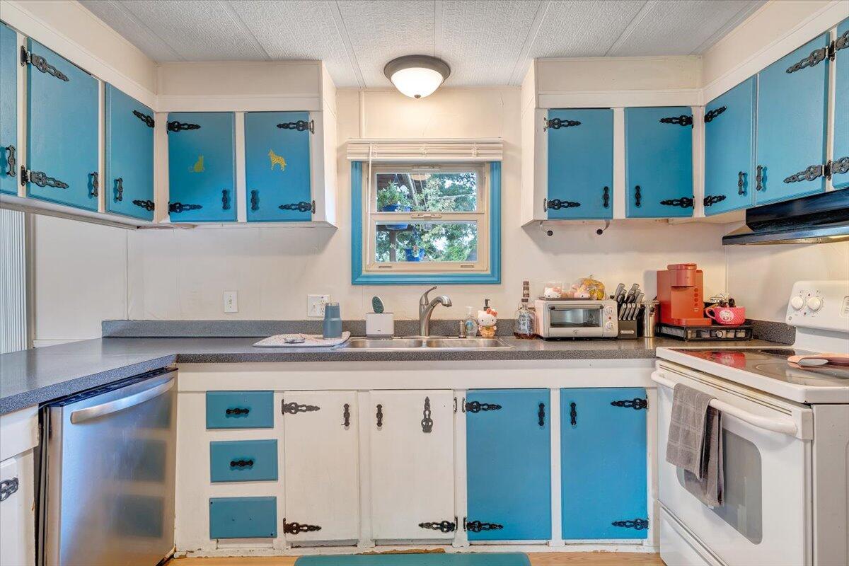 164 Tabernacle Road Penhook, VA 24137 - Photo 10 of 58 a kitchen with stainless steel appliances granite countertop a stove a sink and a microwave