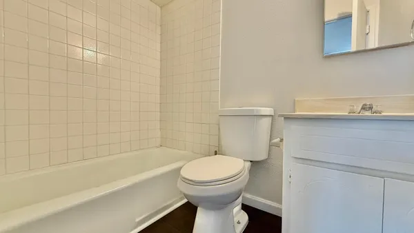 a bathroom with a toilet a sink and bathtub