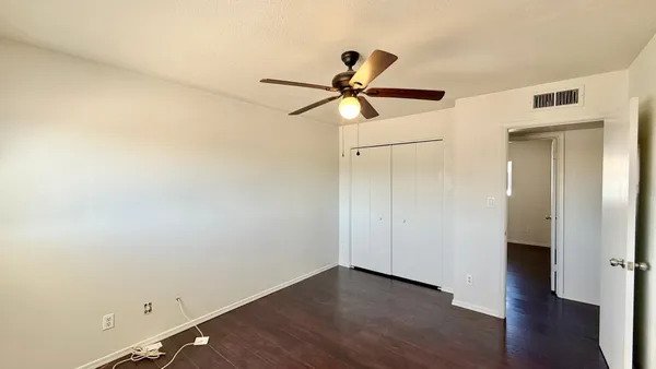 a view of a hallway with wooden floor