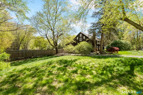 a view of a backyard with large trees