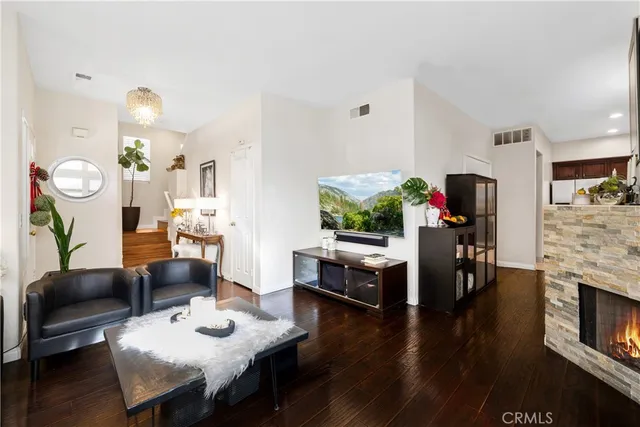 a living room with fireplace furniture and a wooden floor