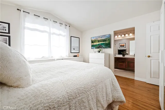 a large bedroom with a bed and a large window