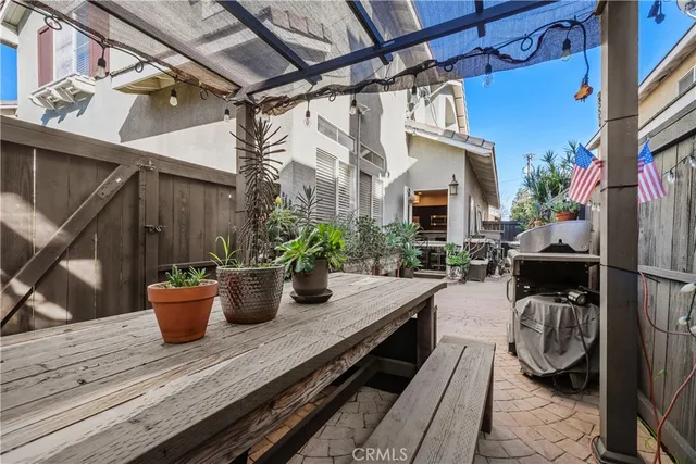 a view of a balcony with chair and potted plants