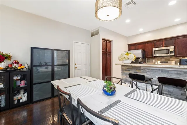 a kitchen with a table chairs and refrigerator