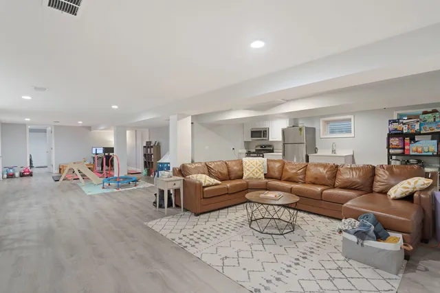 a living room with furniture and a wooden floor