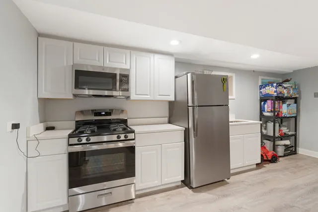 a kitchen with a refrigerator stove and a sink