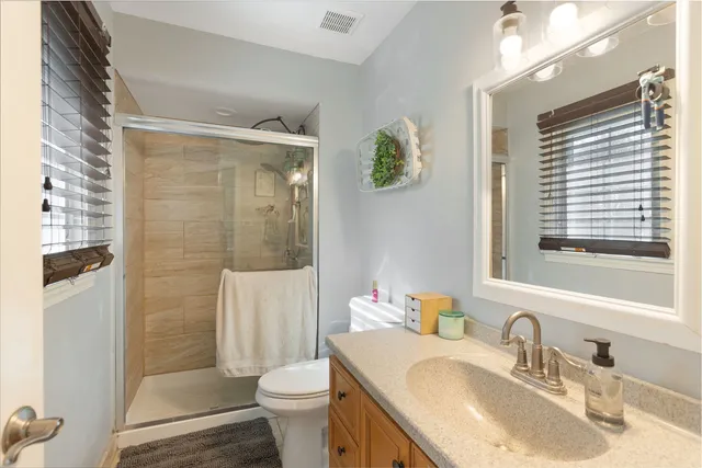 a bathroom with a sink toilet and shower