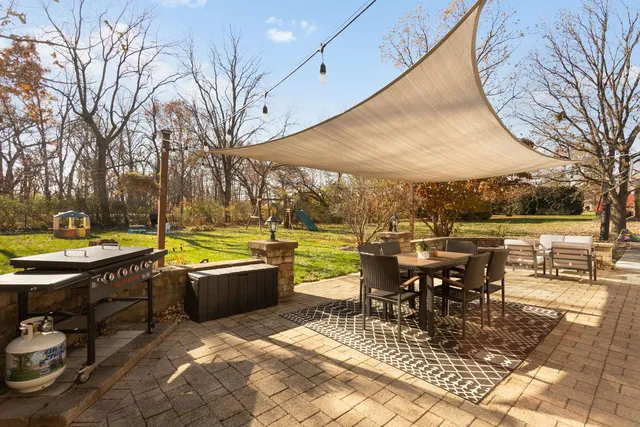 an outdoor space with swimming pool and furniture