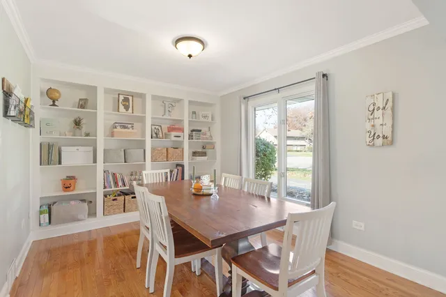 a view of a dining room with furniture and a window