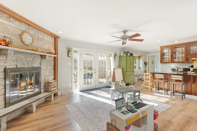 a living room with furniture a fireplace and a table