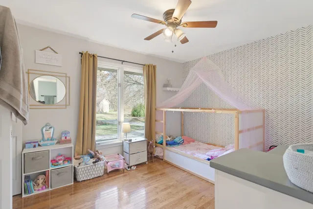 a bedroom with furniture and a window