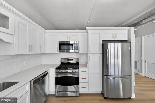 a kitchen with stainless steel appliances granite countertop a stove and a sink
