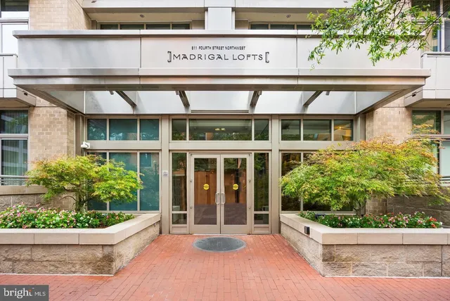 a view of a house with potted plants