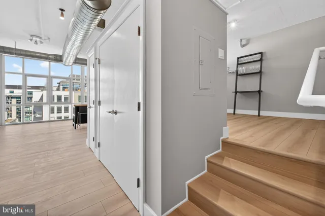 an empty room with wooden floor and white walls