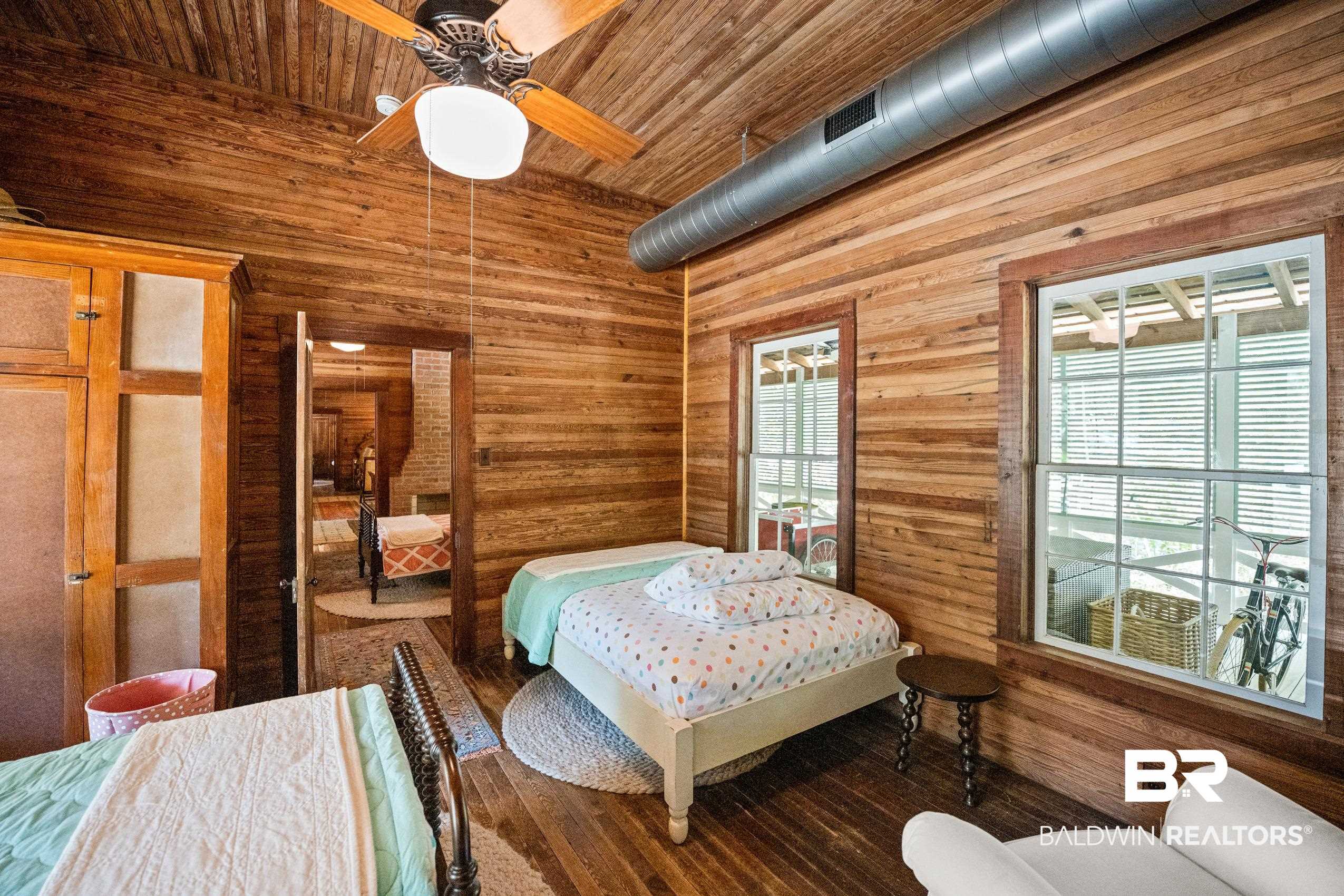 30671 Magnolia Street Elberta, AL 36530 - Photo 29 of 68 Bedroom with wood ceiling, wooden walls, ceiling fan, and wood finished floors