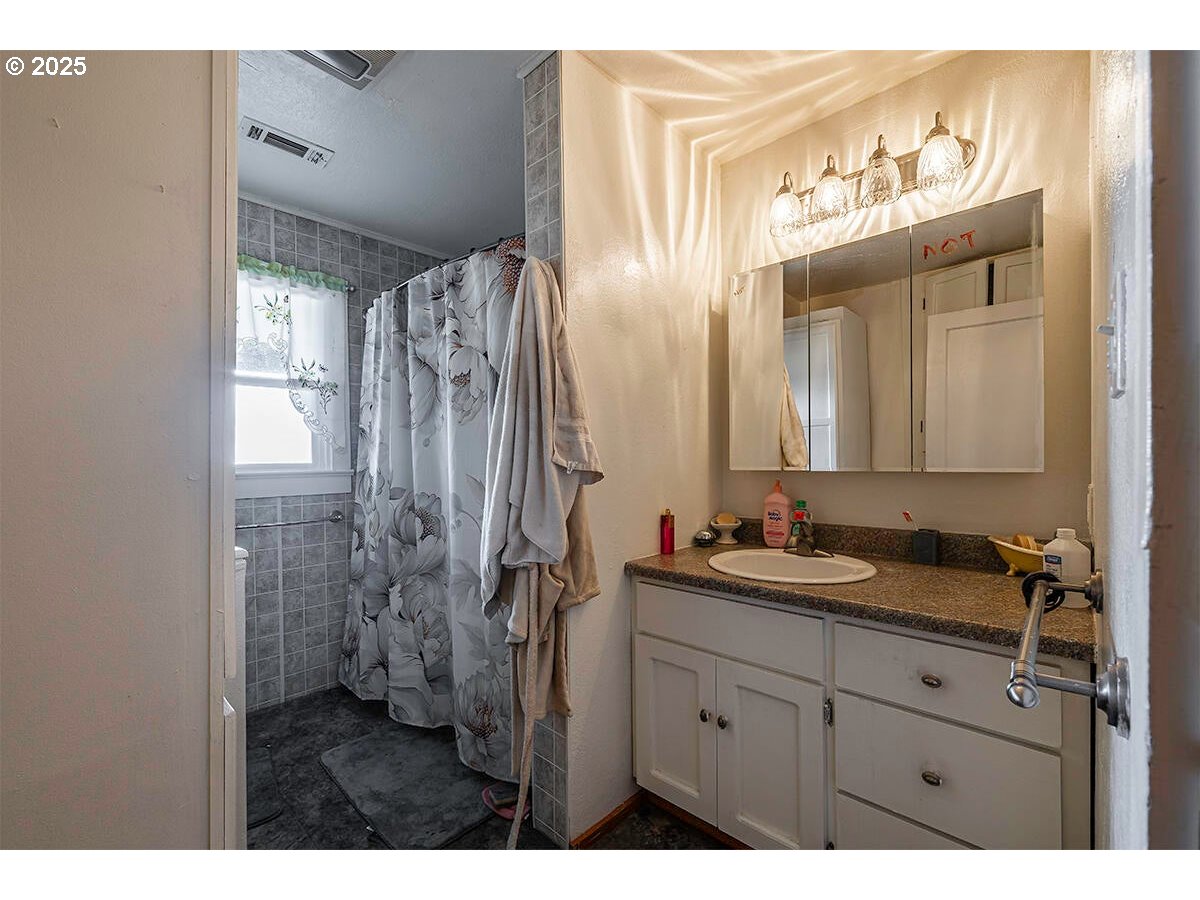 176 Reager Street Medford, OR 97501 - Photo 11 of 48 a bathroom with a double vanity sink mirror and