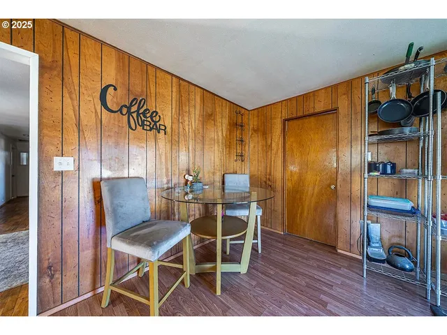 a bedroom with a bed and a large mirror on the dresser