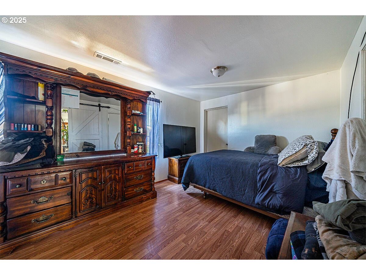 176 Reager Street Medford, OR 97501 - Photo 10 of 48 a bedroom with a bed and a large mirror on the dresser