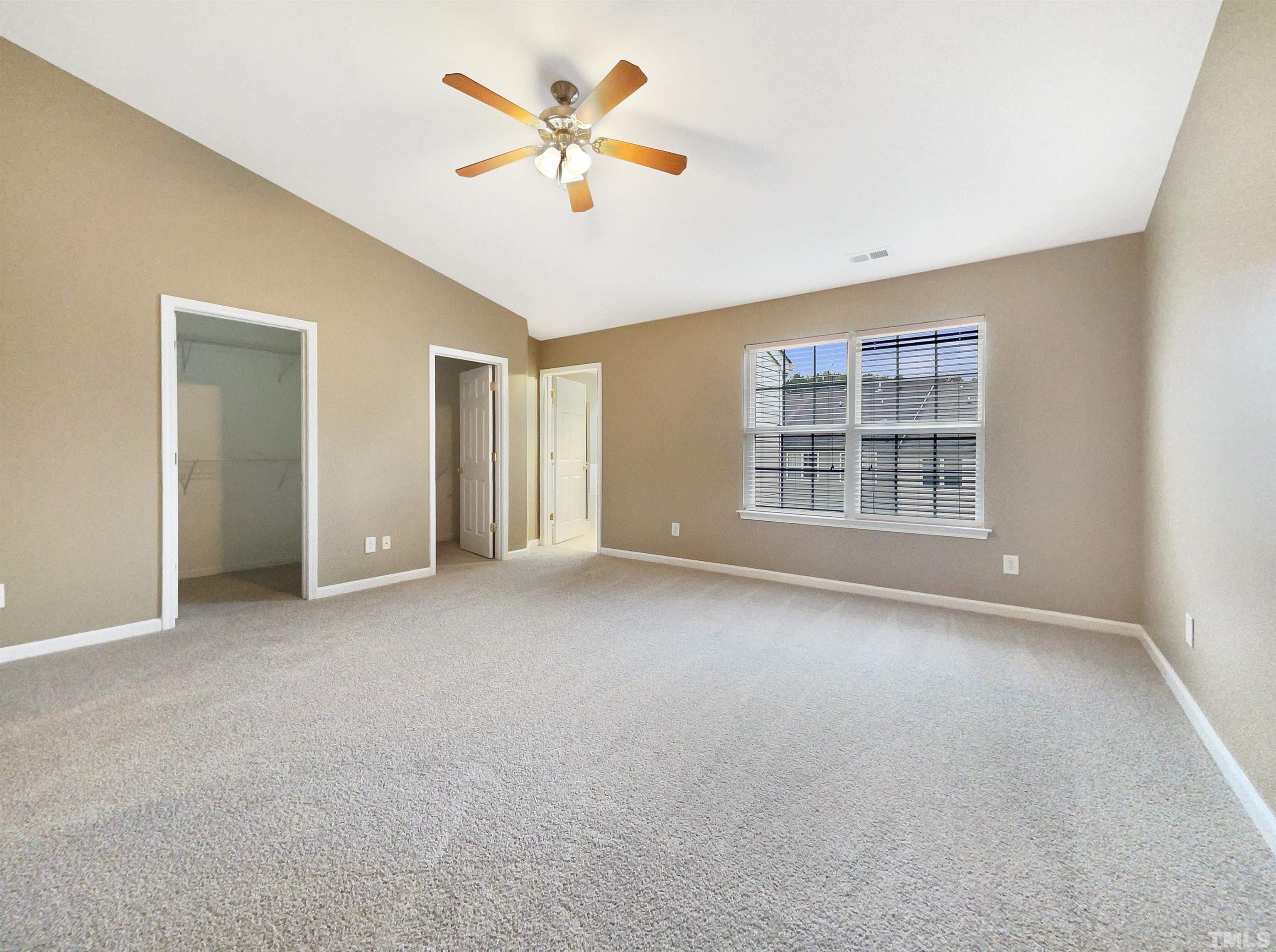 5115 Neuse Commons Lane Raleigh, NC 27616 - Photo 20 of 22 an empty room with windows and ceiling fan